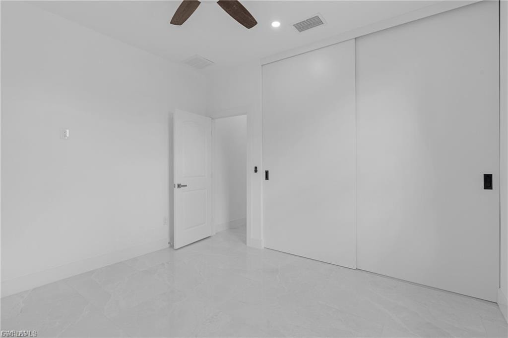 Unfurnished bedroom featuring a closet, ceiling fan, and recessed lighting