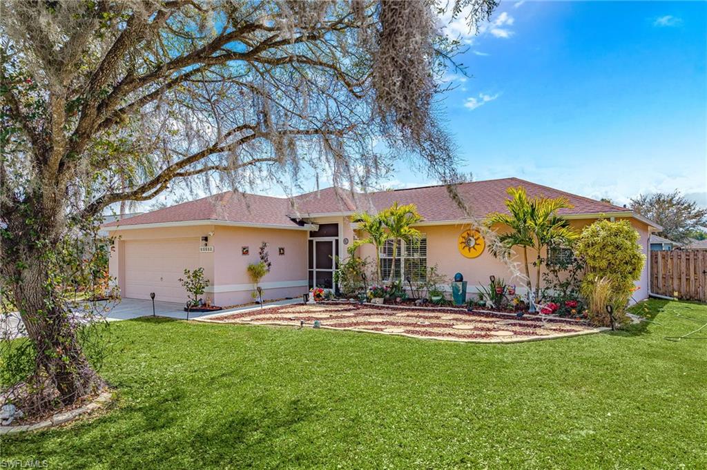 Ranch-style home with a garage, stucco siding, concrete driveway, and a sunroom