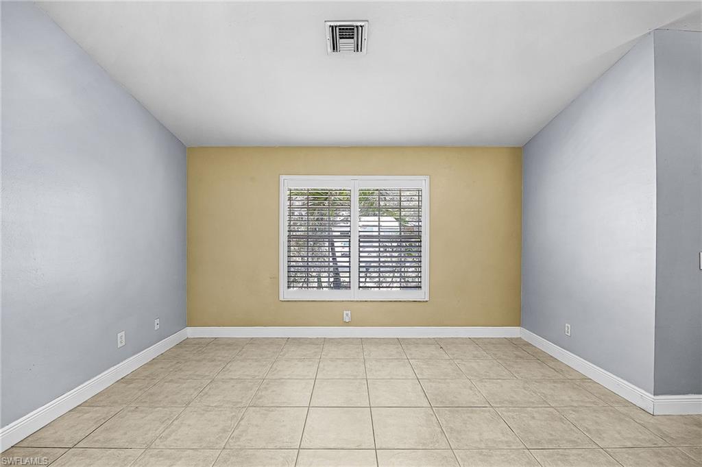 Spare room with baseboards and light tile patterned floors