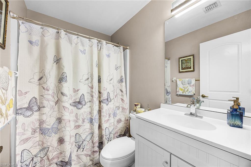 Full bath with vanity and curtained shower