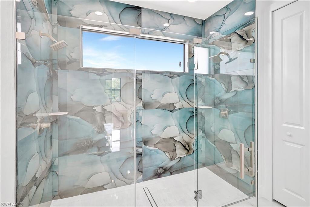 Bathroom featuring a marble finish shower