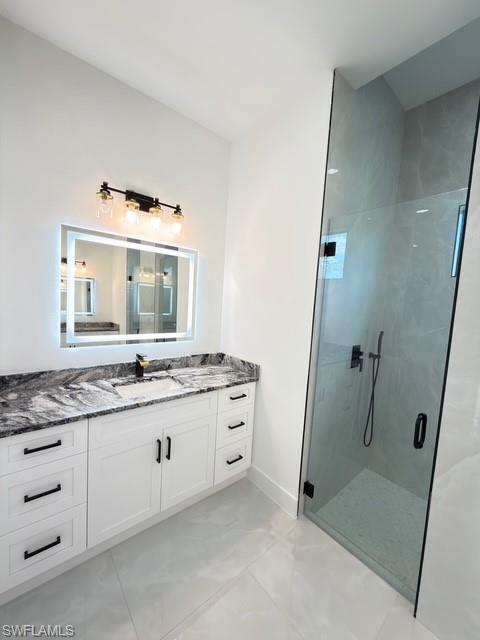 Full bathroom with vanity and a marble finish shower