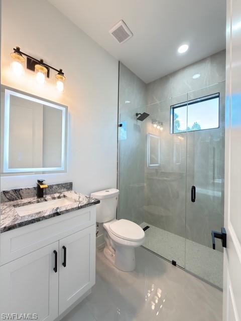 Bathroom with vanity and a stall shower