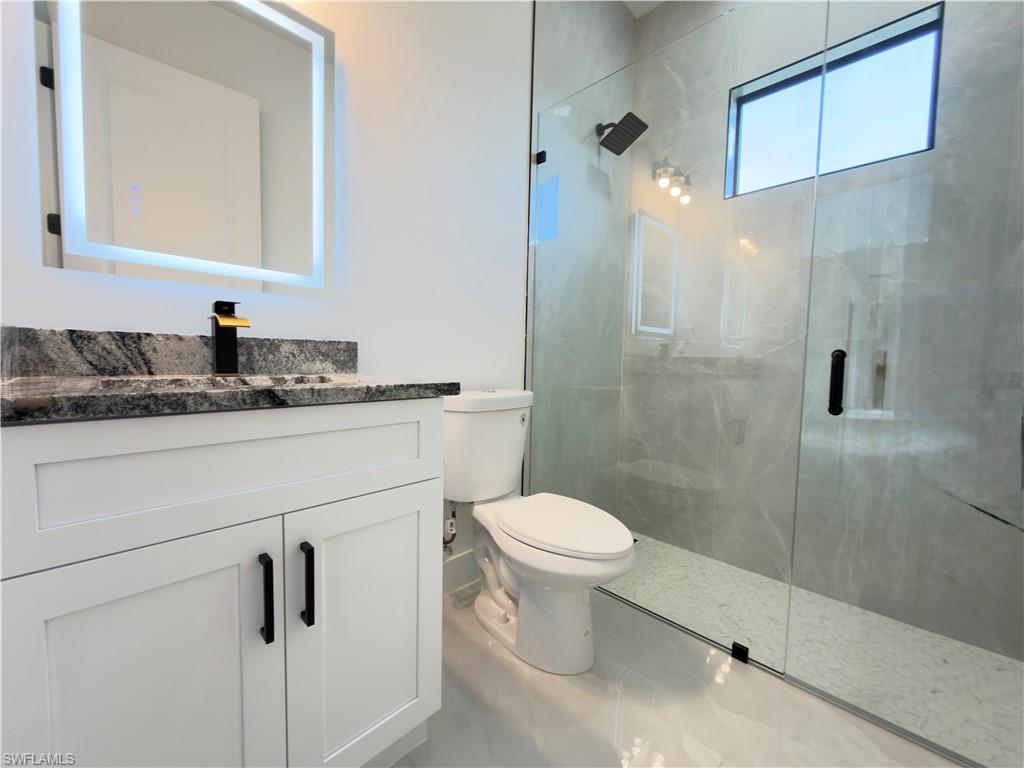 Bathroom featuring vanity and a shower stall