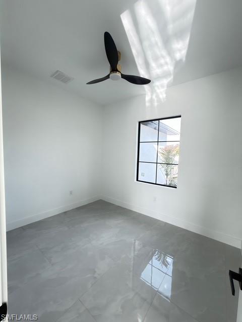 Unfurnished room with baseboards and a ceiling fan