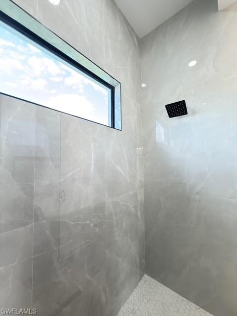 Bathroom with a marble finish shower