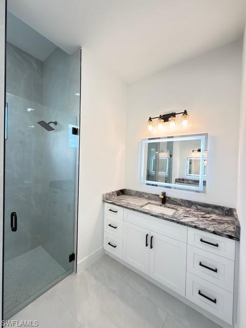 Bathroom with vanity and a shower stall