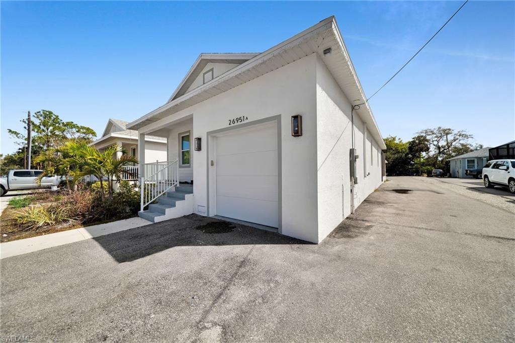 View of side of home featuring stucco siding and an attached garage