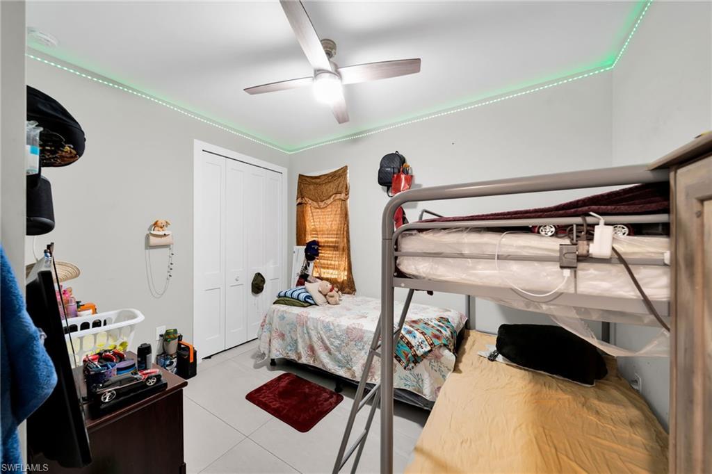 Bedroom featuring a ceiling fan and a closet