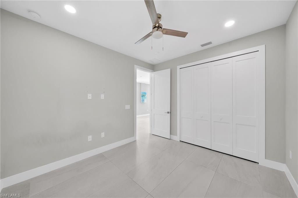Unfurnished bedroom with a ceiling fan, recessed lighting, and a closet