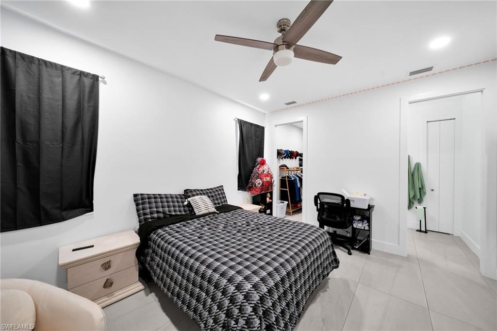 Bedroom featuring ceiling fan, recessed lighting, and a walk in closet