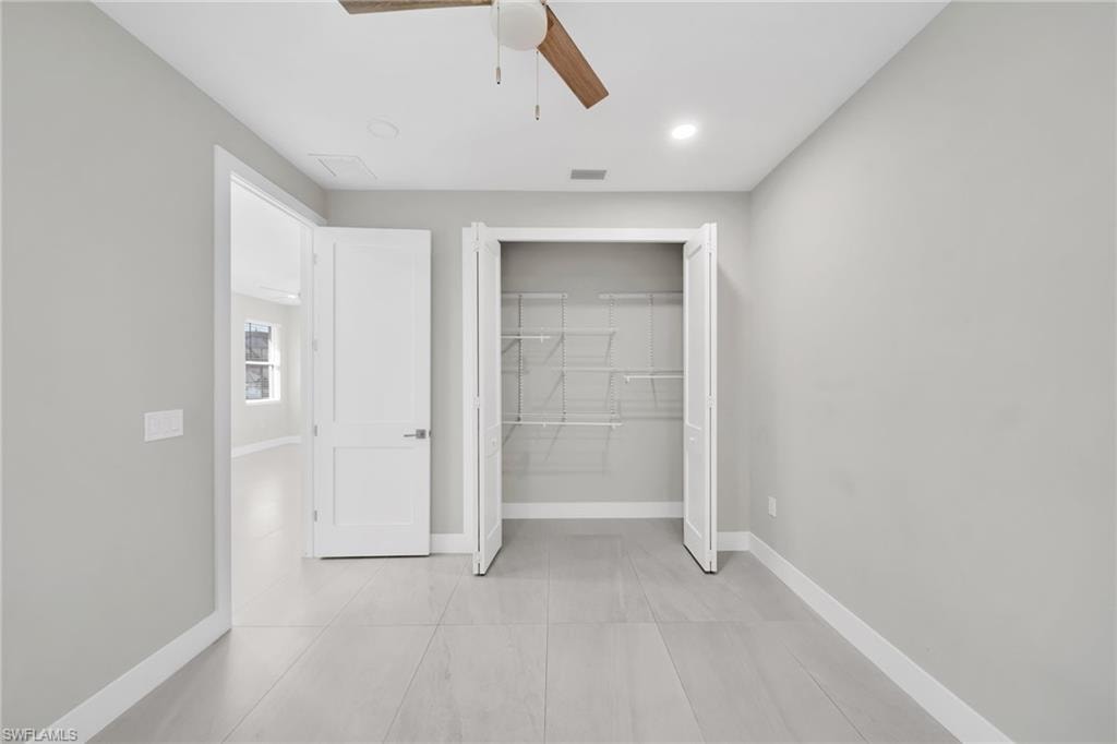 Unfurnished bedroom with a closet, a ceiling fan, and recessed lighting