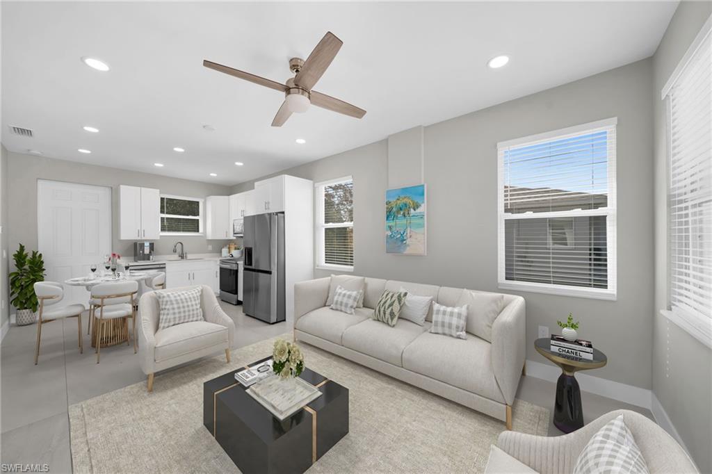 Living room featuring ceiling fan, recessed lighting, and healthy amount of natural light