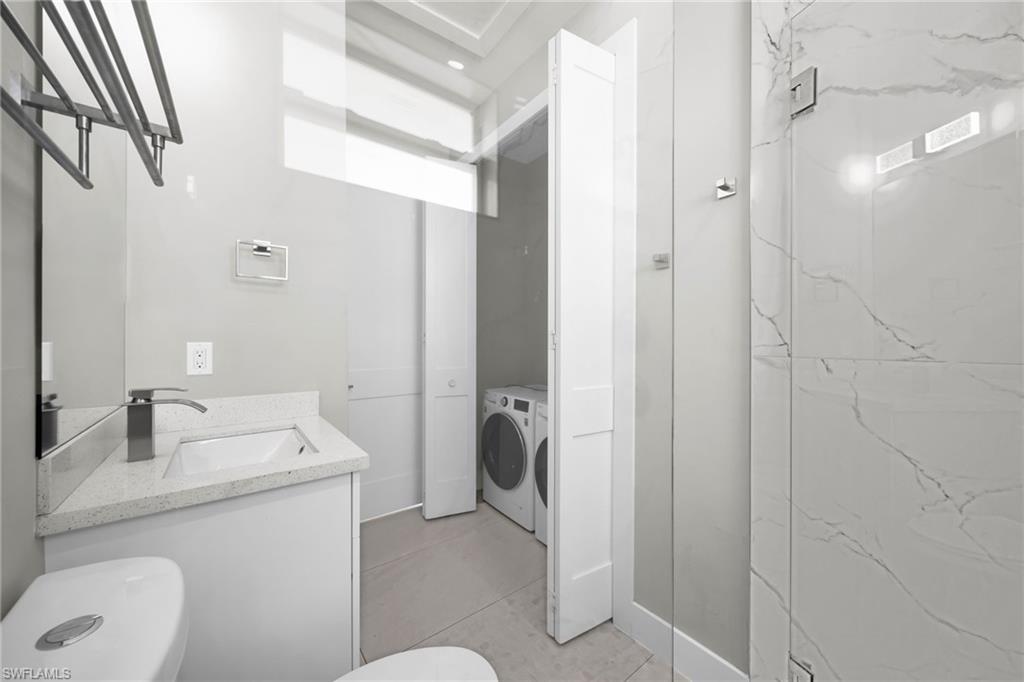 Bathroom featuring vanity and washing machine and dryer
