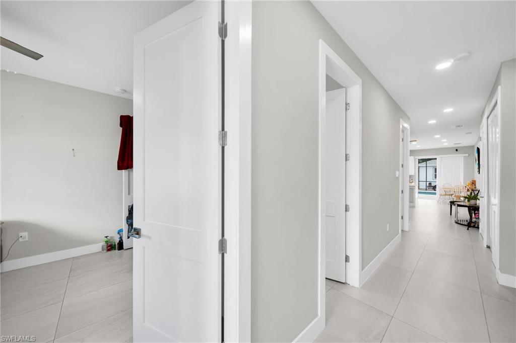 Corridor with recessed lighting and light tile patterned floors