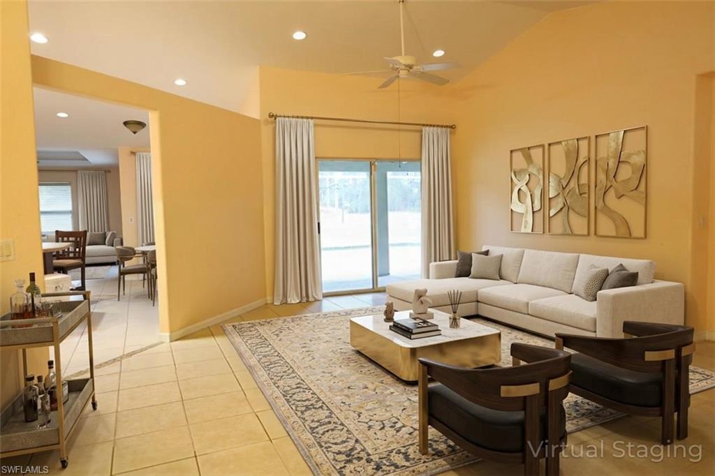 Living area featuring recessed lighting, light tile patterned floors, and a ceiling fan