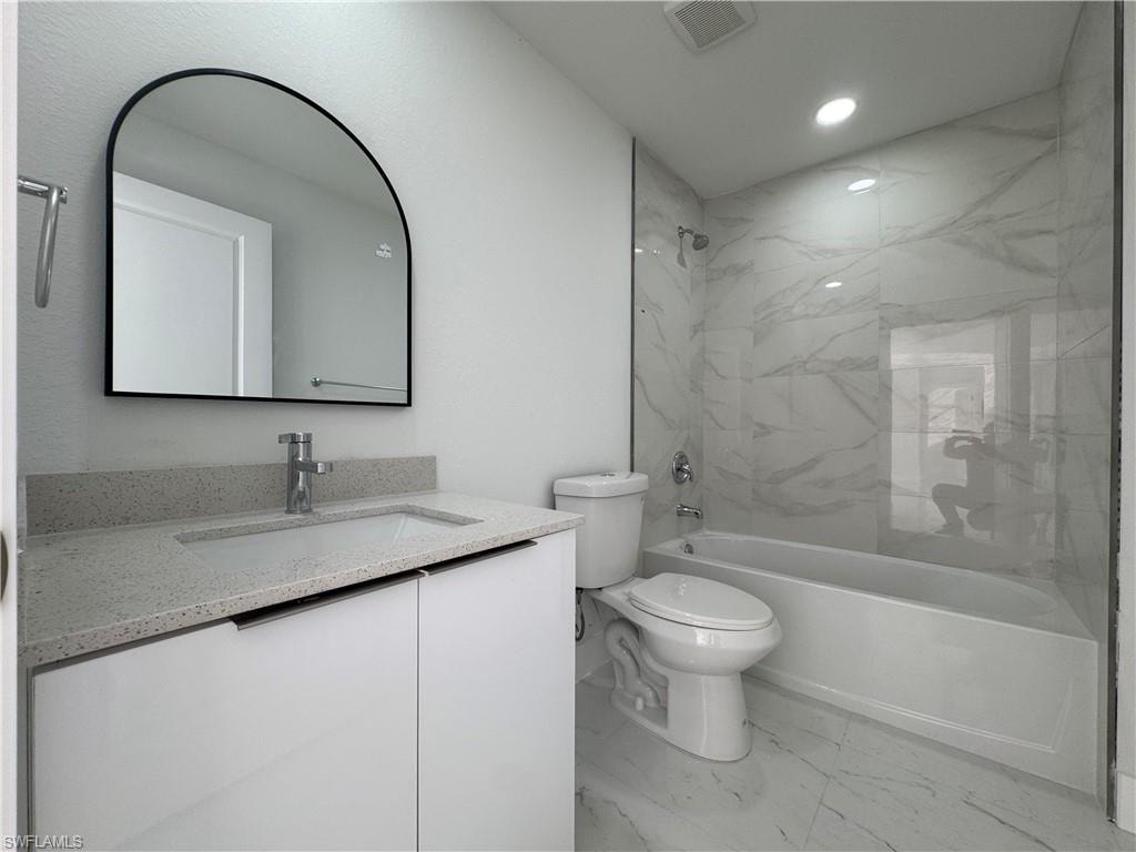 Full bathroom with vanity, light marble finish flooring, bathtub / shower combination, and recessed lighting
