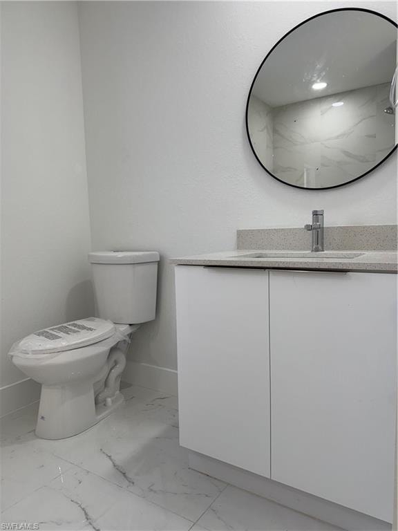 Bathroom with vanity and light marble finish floors