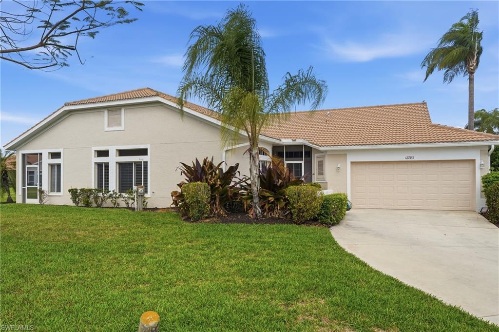 View of front facade featuring stucco siding, a garage, concrete driveway, a front lawn, and a tiled roof