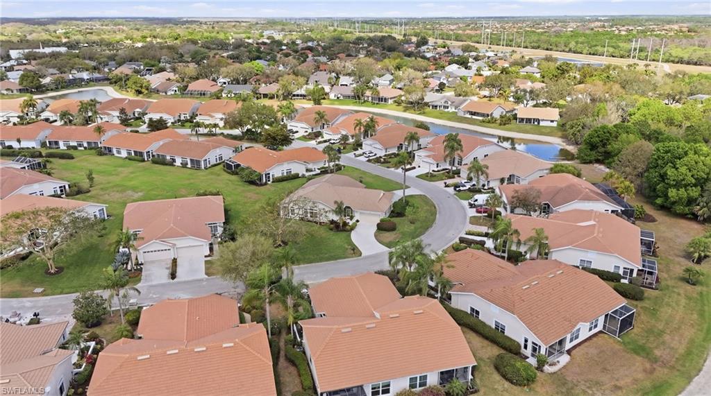 Aerial view of property and surrounding area with nearby suburban area