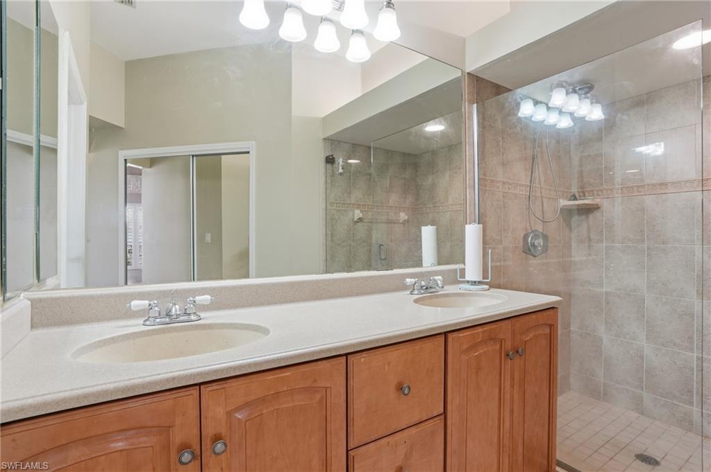 Bathroom with double vanity and a stall shower