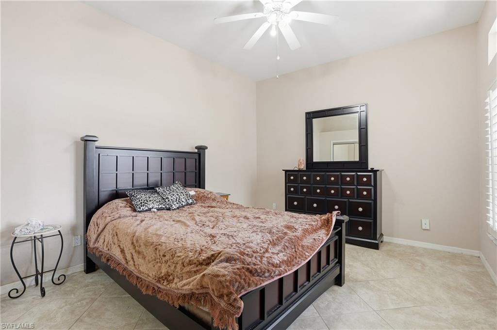 Bedroom featuring a ceiling fan and light tile patterned flooring