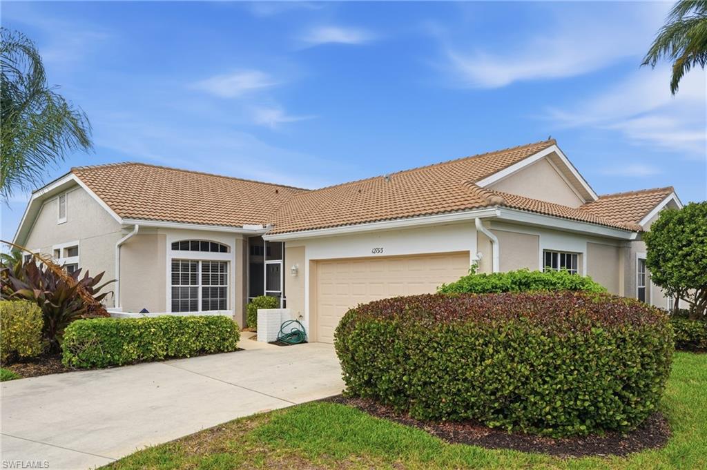 View of front of property featuring stucco siding, a garage, concrete driveway, and a tiled roof