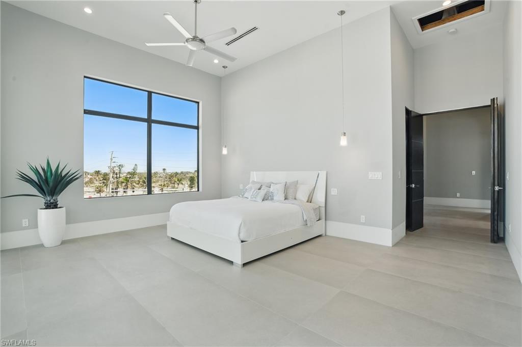 Bedroom with a high ceiling, recessed lighting, and ceiling fan Virtually Enhanced