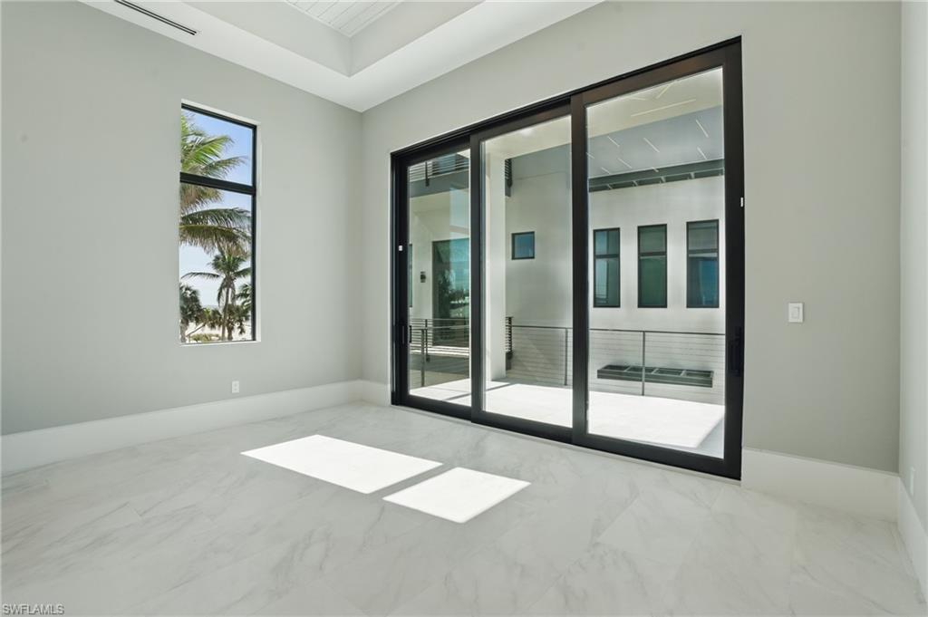 Empty room featuring baseboards and light marble finish flooring Virtually Enhanced