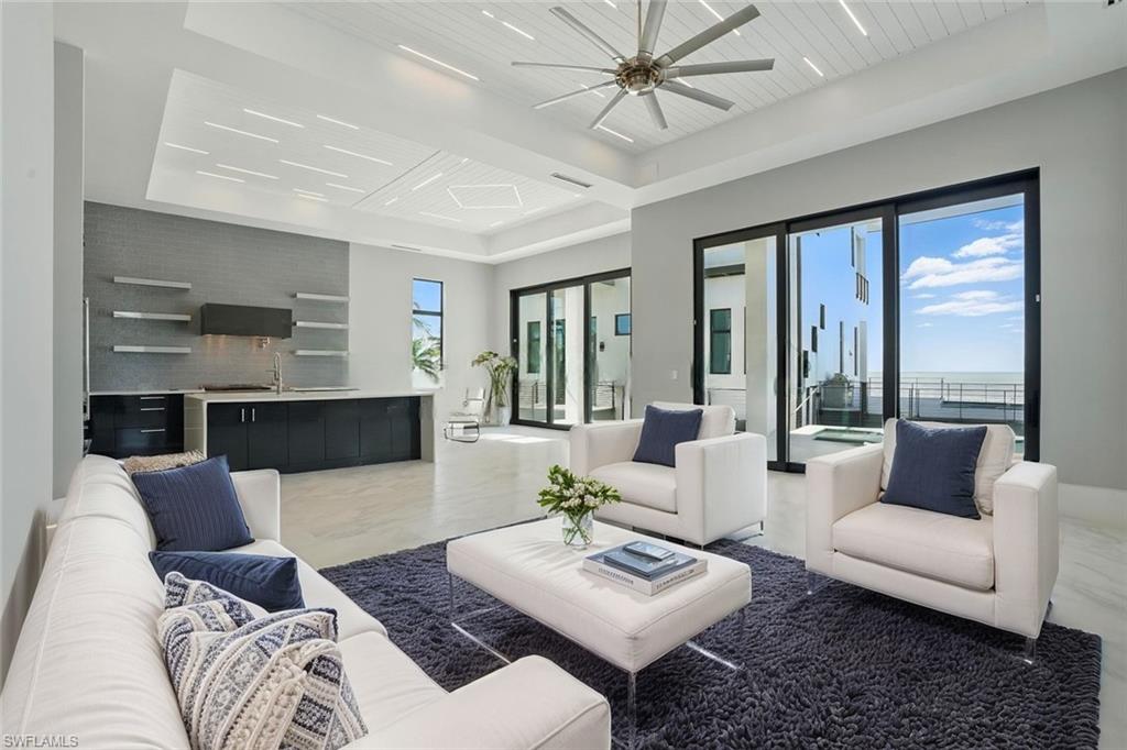 Living area with a ceiling fan and a wooden tray ceilingVirtually Enhanced