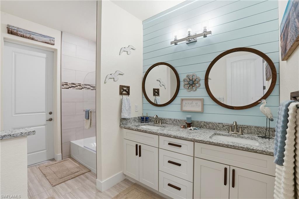 Full bath with double vanity and entrance to lanai