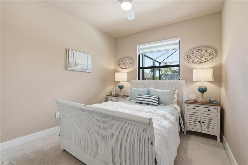 Carpeted bedroom with baseboards and ceiling fan