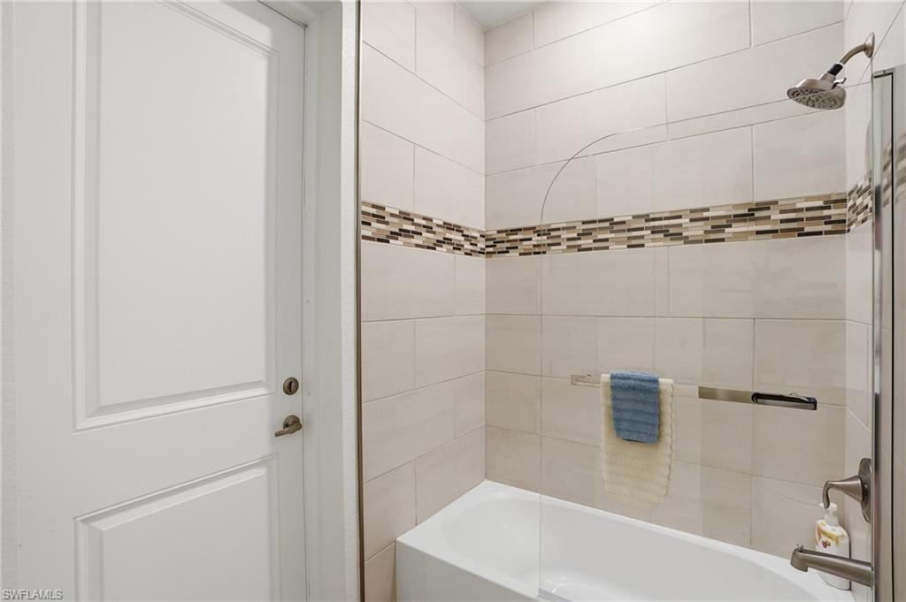 Full bath with shower / tub combination, door to lanai