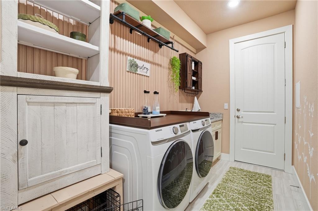 Laundry room featuring washing machine and dryer and storage