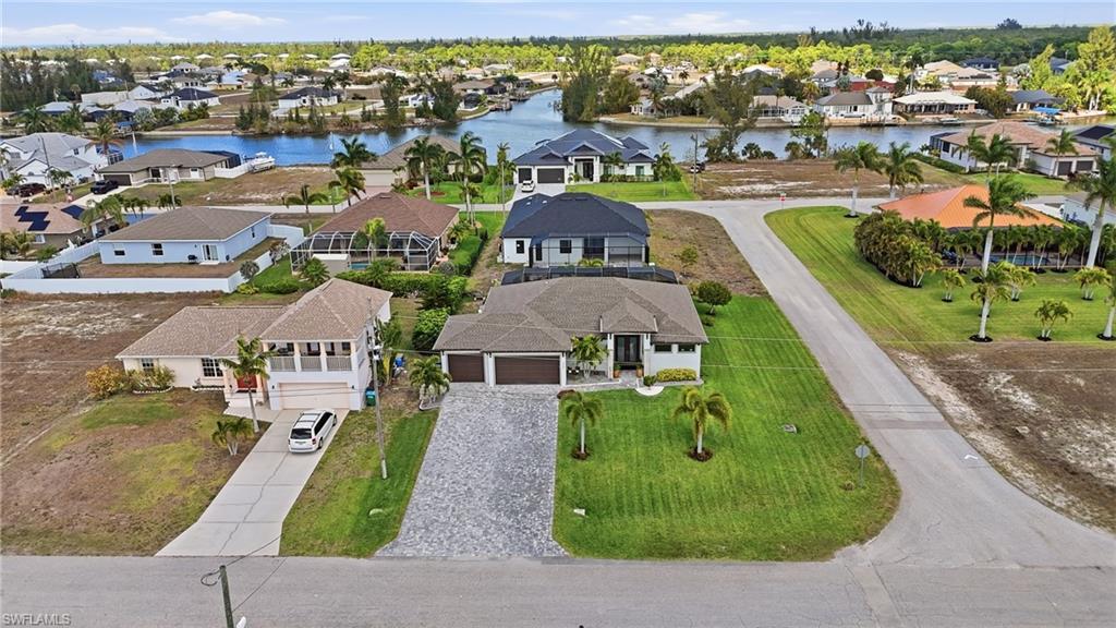 Aerial perspective of suburban area with a nearby body of water, corner lot