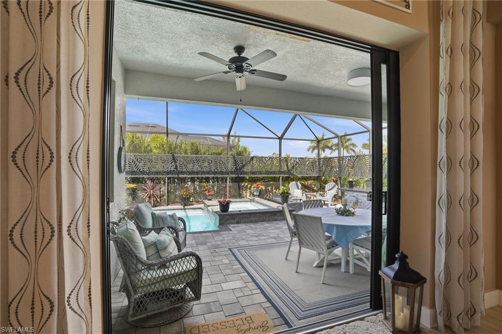 Lanai featuring a patio area, a ceiling fan, a jacuzzi, and a swimming pool