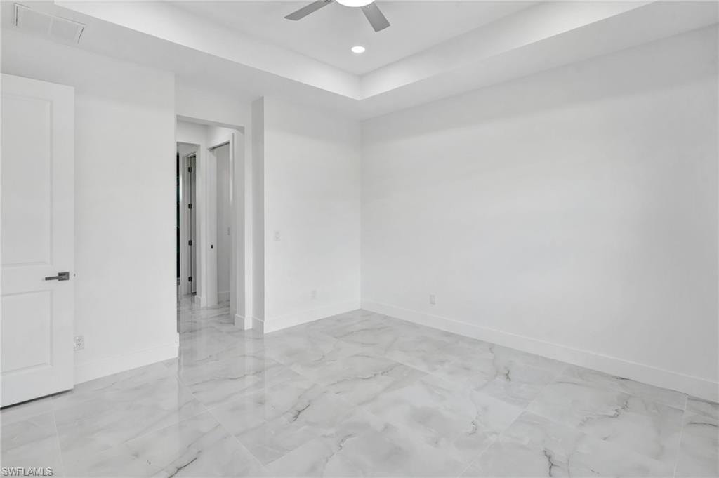 Spare room featuring a ceiling fan, recessed lighting, and light marble finish floors