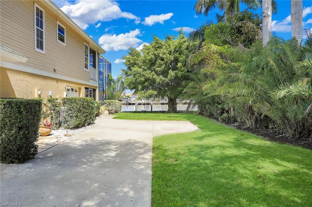 View of grassy yard with a water view