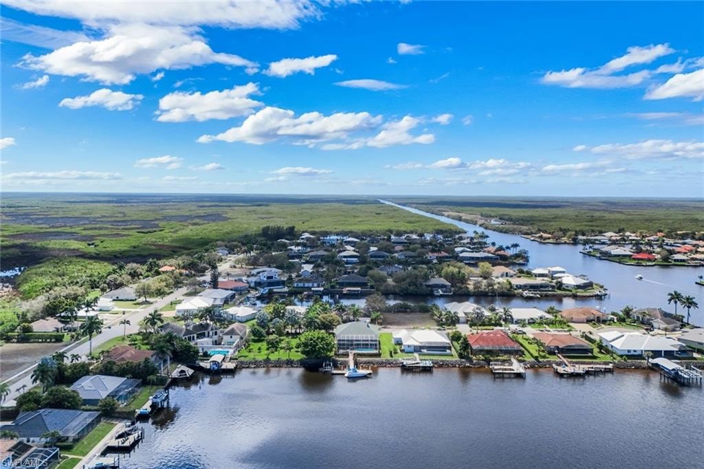 Aerial perspective of suburban area featuring a large body of water