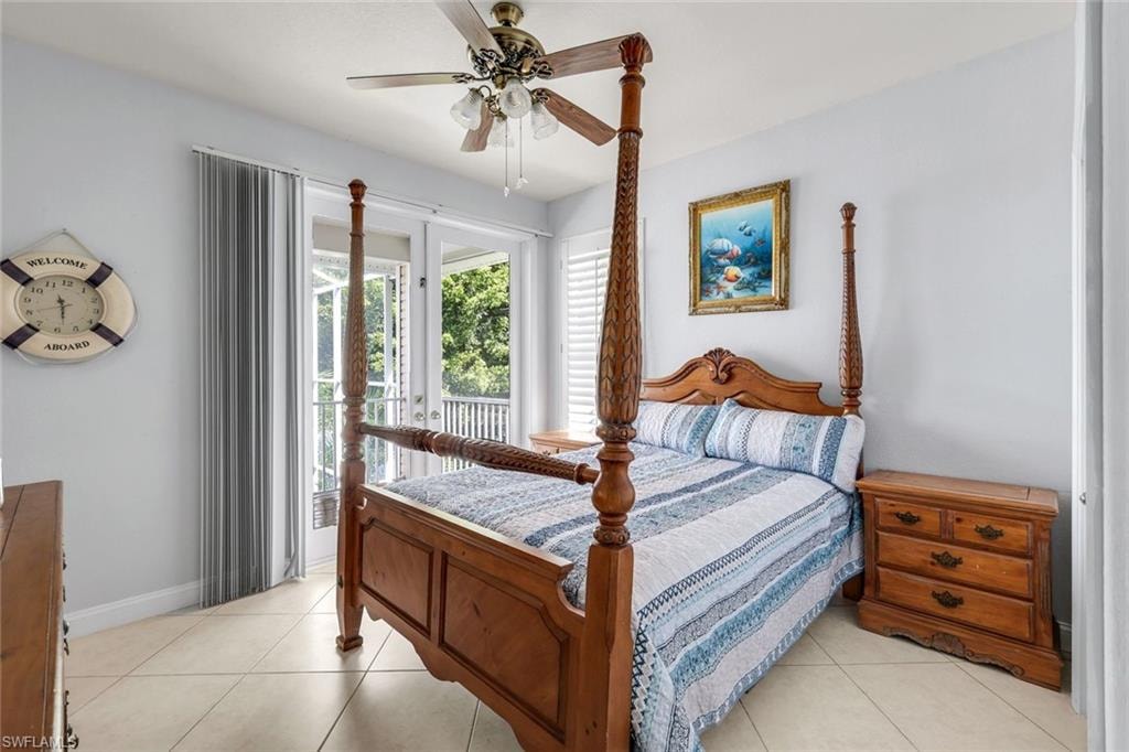 Bedroom featuring access to exterior, a ceiling fan, and light tile patterned floors
