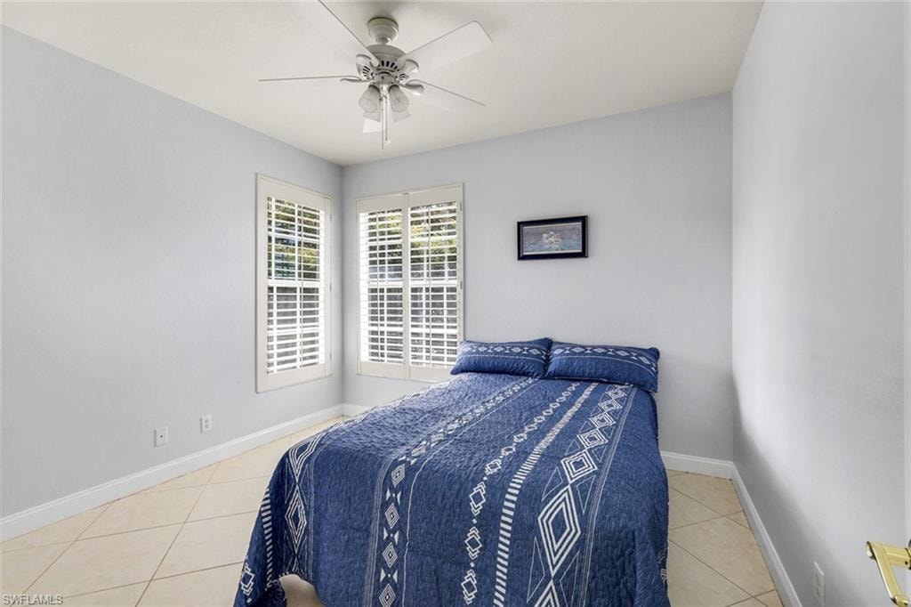 Bedroom featuring light tile patterned floors and ceiling fan