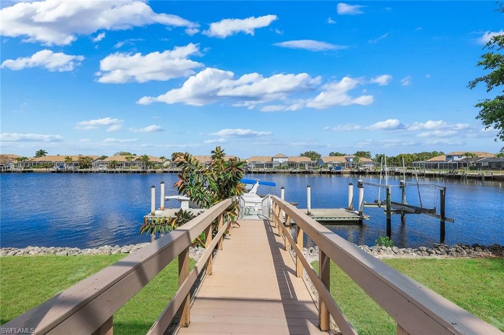 Dock featuring a residential view, a water view, and boat lift