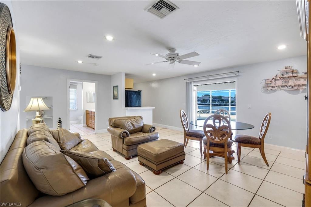 Living room featuring ceiling fan, light tile patterned flooring, plenty of natural light, and recessed lighting
