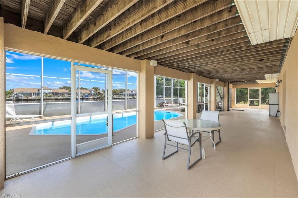 Swimming pool featuring a patio and a water view