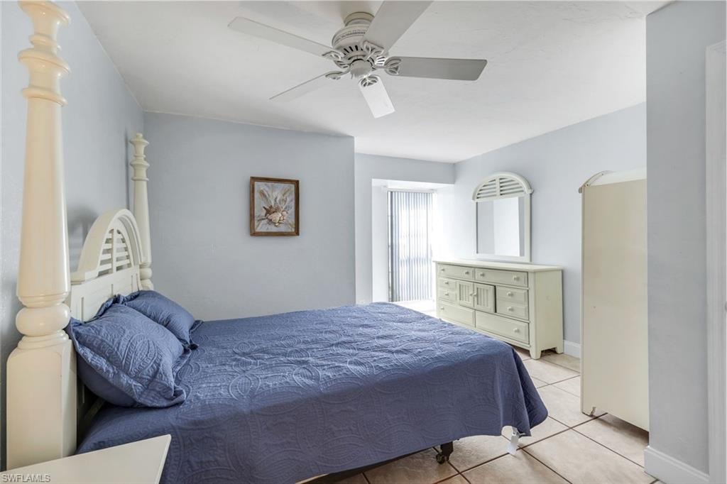 Bedroom featuring light tile patterned floors and ceiling fan