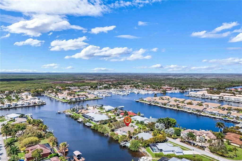 Aerial view of residential area featuring a nearby body of water
