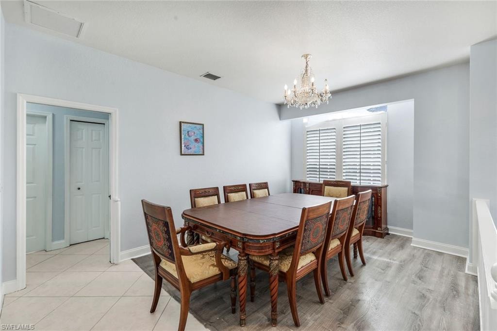 Dining room with baseboards and hanging lights