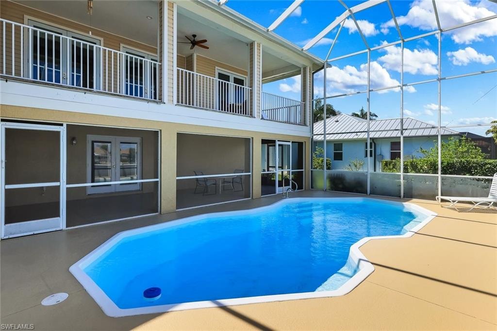 Swimming pool featuring a sunroom and a patio area