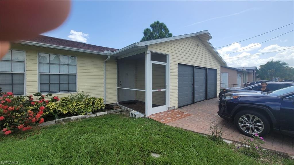 View of side of home with a garage