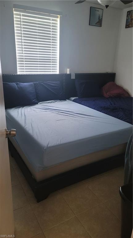 Tiled bedroom with multiple windows